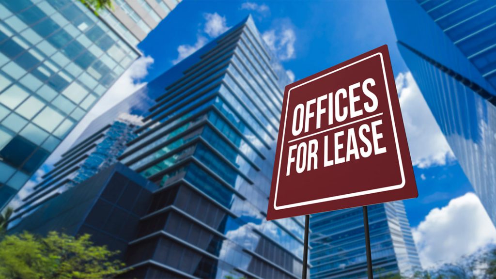 Group of buildings with sign board ‘Offices for lease’ highlighting a corporate environment